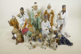 A collection of Chinese Shiwan style mud men figures, tallest 13" high, eighteen total