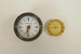 A Tiffany & Co brass clock and another similar cylinder clock, largest 2½" diameter