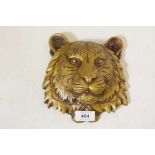 A patinated brass wall plaque in the form of a tiger's mask, 7½" long