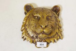 A patinated brass wall plaque in the form of a tiger's mask, 7½" long