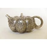 A Chinese white metal teapot in the form of a gourd, with raised decoration of Immortals, 7" x 3"
