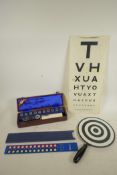 An optician's equipment to include two Keeler cased handheld instruments, a Clement Clarke Snellen