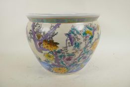 A Chinese porcelain fish bowl decorated with storks and flowering trees, the interior decorated with