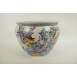 A Chinese porcelain fish bowl decorated with storks and flowering trees, the interior decorated with