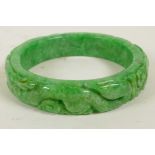 A Chinese carved jade bangle, 3" diameter