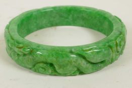 A Chinese carved jade bangle, 3" diameter