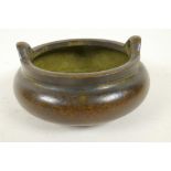 A Chinese bronze censer with two loop handles and raised on three feet, 4 character mark to base,