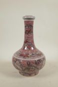A Chinese red and white porcelain bottle vase with stylised decoration of kylin in a landscape, 6