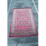 An Afghan style full pile red ground rug, 62" x 91"