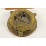 A brass sundial/compass in a fitted hardwood box