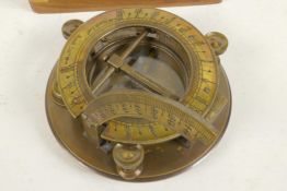 A brass sundial/compass in a fitted hardwood box