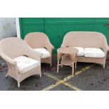 A wicker conservatory suite, comprising a two seat settee, a pair of tub chairs and an occasional