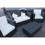 A contemporary woven garden suite consisting of two armchairs, a two seater sofa and coffee table,