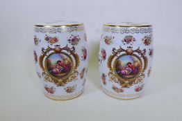 A pair of porcelain garden stools decorated in the European manner with flowers and panels of