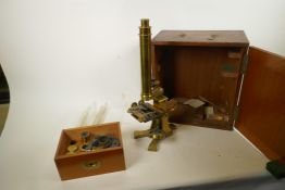 A C19th brass microscope, comes with accessories, in a fitted case, by John Robbins of London,