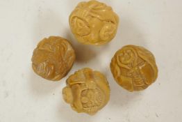 Four Oriental nuts carved with various figures, 1¼"