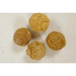 Four Oriental nuts carved with various figures, 1¼"