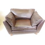 A contemporary brown leather armchair, 48" wide