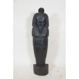 An Egyptian carved and lacquered wood figure of a pharoah, 39½" high