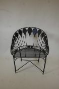 An Indian wrought metal garden tub chair with peacock feather/balloon decoration, 35" high
