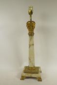 An onyx and ormolu table lamp formed as a classical column on a square base, 23" high