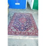 A Belgian blue ground wool carpet with Persian floral pattern decoration and a red border, 98" x