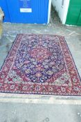 A Belgian blue ground wool carpet with Persian floral pattern decoration and a red border, 98" x