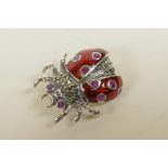 A 925 silver and enamel ladybird brooch set with marcasite and rubies, 1"