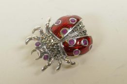 A 925 silver and enamel ladybird brooch set with marcasite and rubies, 1"