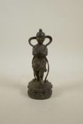 A Chinese bronze figure of a child standing on a lotus flower plinth, with gilt patina, 7½" high