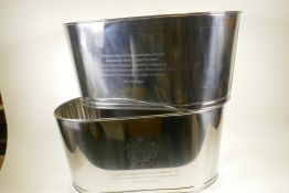 A pair of large chrome plated oval champagne coolers engraved with aphorisms from Lily Bollinger and