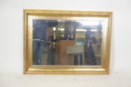 A gilt composition overmantle mirror with a cushion frame, 45" x 34"