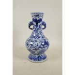 A Chinese Ming style blue and white porcelain two handled vase decorated with dragons and phoenix, 6