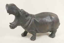 A bronzed cast metal figure of a hippopotamus, 13½" long