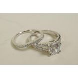 Two silver and cubic zirconium rings with encrusted shoulders, approximate size 'O/P'