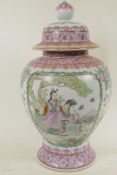 A Chinese famille rose porcelain vase and cover decorated with figures, 16" high