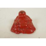 A small Cinnabar lacquer figurine of Buddha, 1¼" high