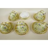 A GD & Co. Limoges porcelain part teaset painted with forget me nots on a pale yellow ground, 10 x