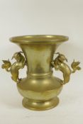 A brass vase with flared neck and two cast fo dog handles, 11" high