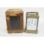 A French brass cased carriage clock with white enamel dial and Roman numerals, retailed by