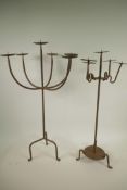 A wrought iron six light pricket candlestick, A/F, together with a smaller five light pricket