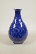A Chinese blue glazed porcelain pear shaped vase with underglaze scrolling floral decoration, 6
