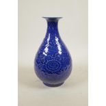 A Chinese blue glazed porcelain pear shaped vase with underglaze scrolling floral decoration, 6