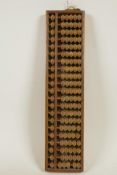 A Japanese wooden bead abacus in a hardwood frame, 13½" x 13½"