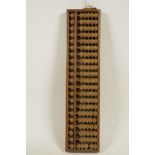 A Japanese wooden bead abacus in a hardwood frame, 13½" x 13½"