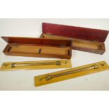 Two mahogany cased boxwood and brass 18" rolling rules by J.A. Nicholl & Co.