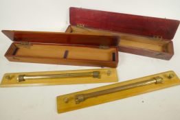 Two mahogany cased boxwood and brass 18" rolling rules by J.A. Nicholl & Co.