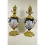 A pair of Continental porcelain and ormolu table lamp bases decorated with cartouches of classical