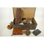 An ammunition box containing a quantity of vintage fishing equipment including wood and brass