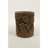 A Chinese carved and pierced bamboo brush pot decorated with Lohan and auspicious animals, 6" high